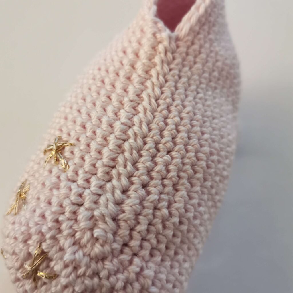 body part of pink crochet unicorn with stars
