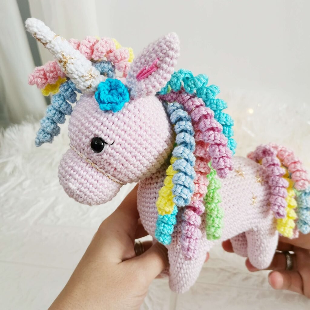 Finished amigurumi made using the free unicorn crochet pattern.