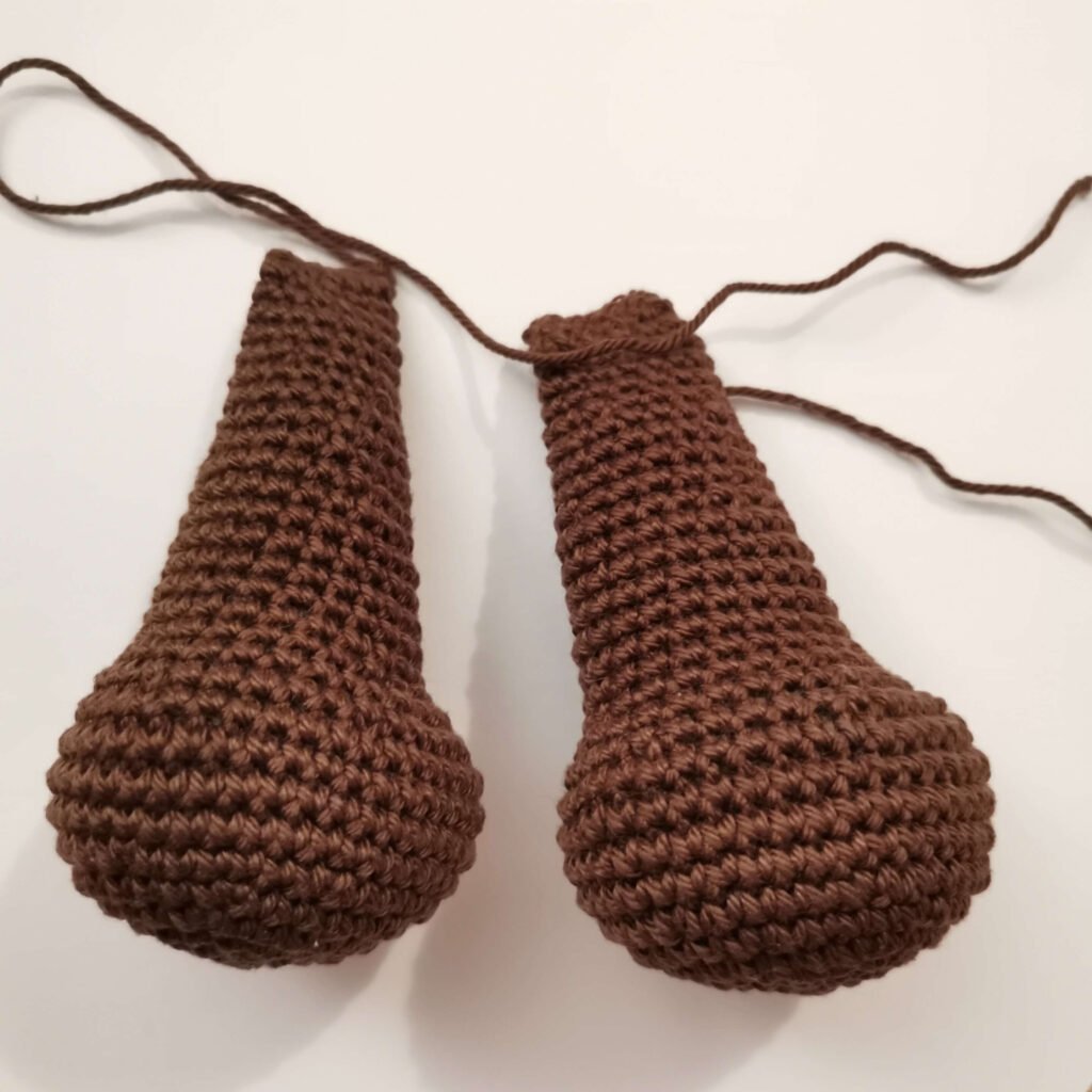 Two finished dark brown crochet legs for a classic amigurumi teddy bear free pattern by EmmaS Dolls